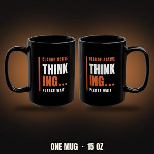 May include: Two black ceramic mugs with a handle on the side. The text on the front reads CLAUDE ACTIVE THINK ING... PLEASE WAIT in white and orange lettering. The mugs have a 15 ounce capacity as indicated by the text at the bottom of the image.