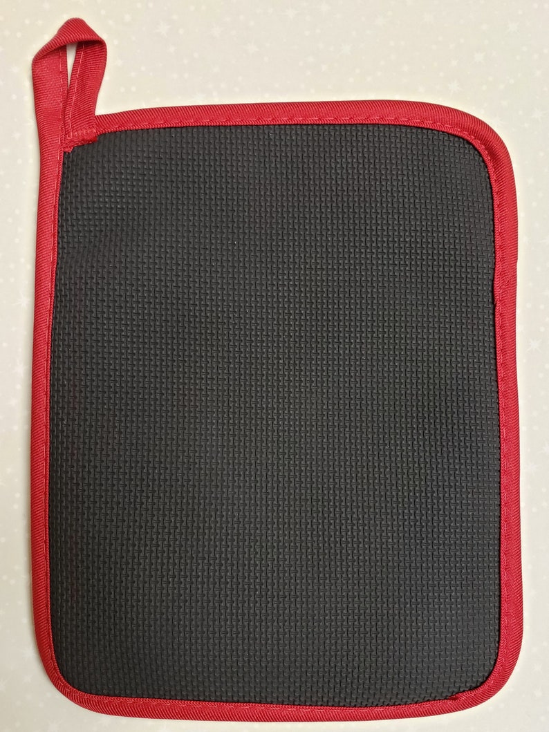 May include: A black heat-resistant pot holder with a red stitched border and a red loop handle.
