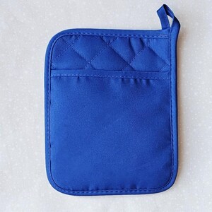 May include: A blue quilted pot holder with a hanging loop. The pot holder is made of a thick, heat-resistant fabric.