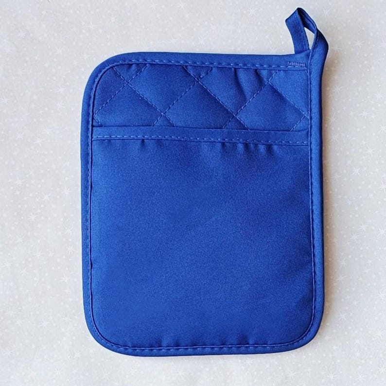 May include: A blue quilted pot holder with a hanging loop. The pot holder is made of a thick, heat-resistant fabric.