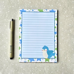 May include: Blue lined notepad with a blue and green star border. A cartoon blue bird with a white belly is in the bottom right corner.