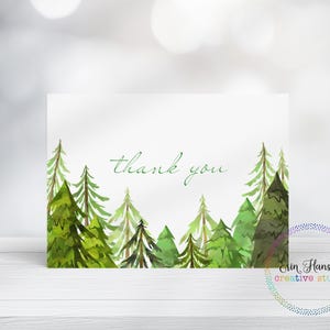May include: A thank you card with a watercolor illustration of a forest scene. The card is white with green trees and the words "thank you" in cursive.