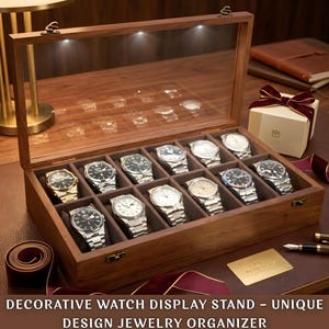 May include: A wooden watch display case with a glass top, illuminated by small lights. The case is open, revealing a collection of silver and gold watches. The text at the bottom reads: DECORATIVE WATCH DISPLAY STAND - UNIQUE DESIGN JEWELRY ORGANIZER.