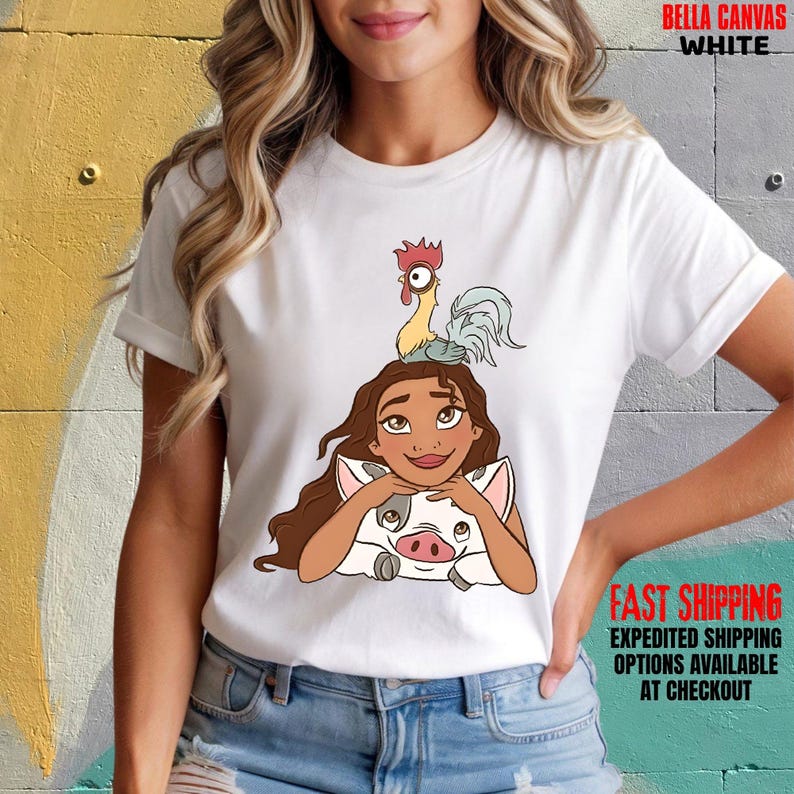May include: White Bella Canvas t-shirt with a cartoon illustration of a woman, a pig, and a rooster. The shirt has rolled-up sleeves. The text "BELLA CANVAS WHITE" is printed at the top. The words "FAST SHIPPING" are printed at the bottom.