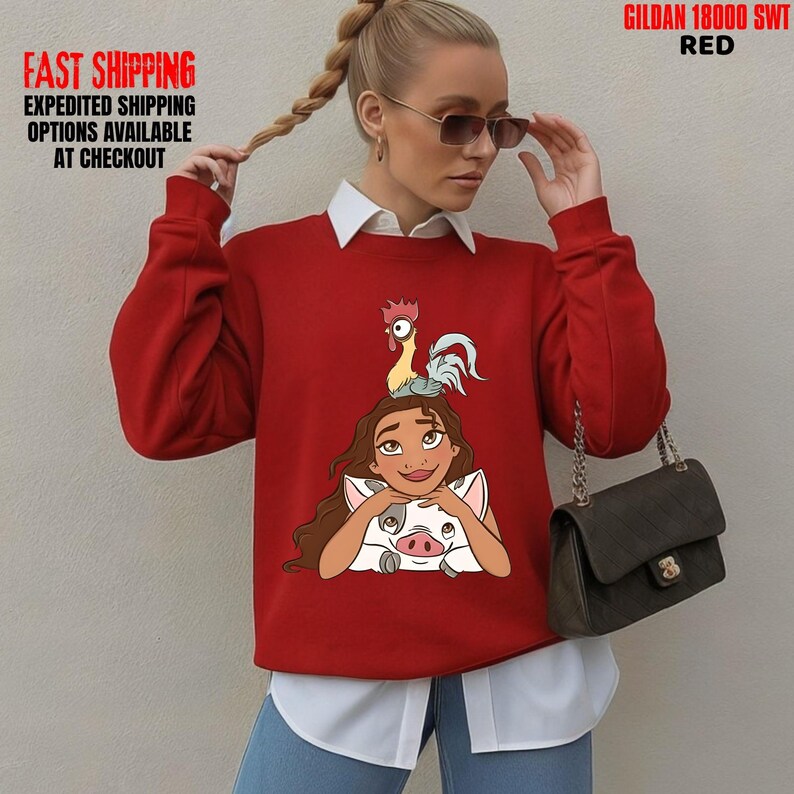 May include: A red sweatshirt featuring a cartoon character with a rooster and a pig graphic. The sweatshirt has long sleeves and a white collar. The text "FAST SHIPPING EXPEDITED SHIPPING OPTIONS AVAILABLE AT CHECKOUT" is visible on the left side of the image.