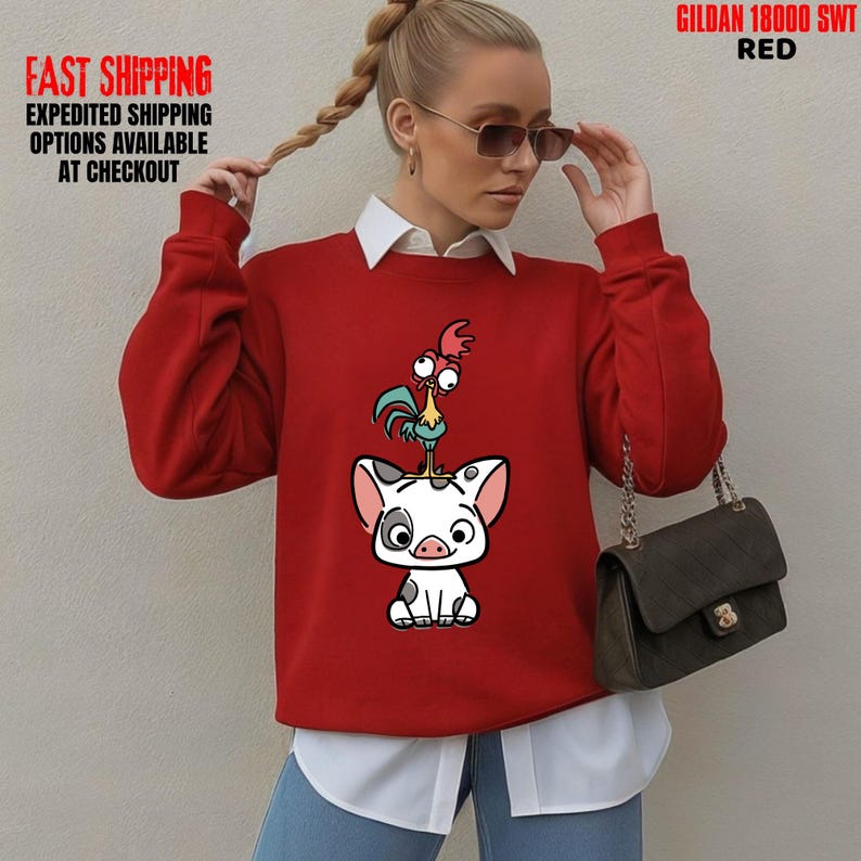 May include: A red sweatshirt featuring a cartoon illustration of a pig with a rooster on its head. The sweatshirt has the text "GILDAN 18000 SWT RED" printed on it.