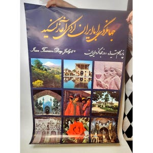 May include: A large vertical poster with a dark blue background featuring gold Persian calligraphy and the text Iran Tourism Day, July 6th. It displays a grid of nine photographs showing landscapes, historical architecture, a stone relief, and a red rose.