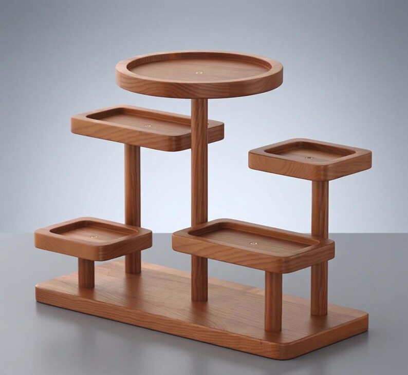 May include: A multi-tiered wooden display stand with a natural finish. It features a rectangular base and several platforms of varying shapes and sizes, supported by cylindrical posts. The stand is designed to showcase items.