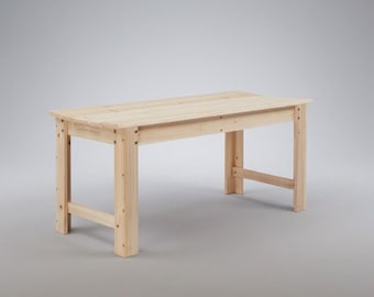 May include: A light-colored, rectangular wooden table with a simple design. The table has four legs and a flat top, constructed from planks of wood. The table is approximately 60 inches long and 30 inches wide.