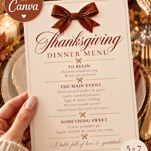 May include: A 5x7 inch Thanksgiving dinner menu card featuring a brown velvet bow at the top. The text lists courses including roasted pumpkin soup, herb-roasted turkey, and classic pumpkin pie, with the phrase A table full of love & gratitude.