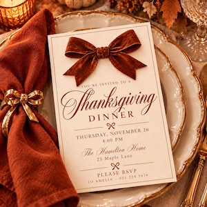 May include: A rectangular cream-colored Thanksgiving dinner invitation card featuring a dark orange velvet bow at the top. The text reads: You're invited to a Thanksgiving dinner, Thursday, November 26, 4:00 PM, The Hamilton Home, 25 Maple Lane, Please RSVP to Amelia - 021 234 5678.