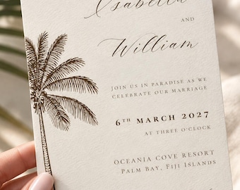 May include: A cream-colored wedding invitation card featuring a dark brown illustration of a palm tree on the left side. The text reads: Together with their families, Isabella and William, join us in paradise as we celebrate our marriage, 6th March 2027, at three o'clock, Oceania Cove Resort, Palm Bay, Fiji Islands, Sunset cocktails, dinner & dancing to follow.