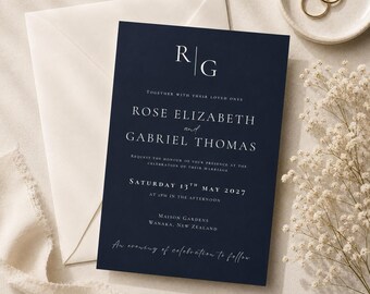 May include: A navy blue wedding invitation card featuring white serif typography and the monogram R|G. The text reads Rose Elizabeth and Gabriel Thomas, Saturday 13th May 2027, at 4pm in the afternoon, Maison Gardens, Wanaka, New Zealand, and an evening of celebration to follow.