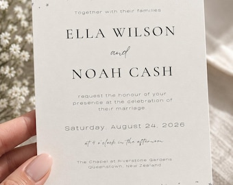 May include: A white wedding invitation card featuring silver foil star confetti patterns at the top and bottom edges. The text reads: Together with their families, ELLA WILSON and NOAH CASH request the honour of your presence at the celebration of their marriage. Saturday, August 24, 2026 at 4 o'clock in the afternoon. The Chapel at Riverstone Gardens, Queenstown, New Zealand.