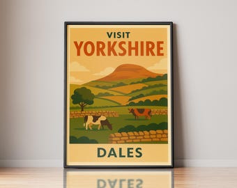 May include: A framed travel poster featuring a landscape of the Yorkshire Dales with rolling green hills, a large brown hill in the background, stone walls, and two cows grazing in a field. The text reads VISIT YORKSHIRE DALES in bold letters.