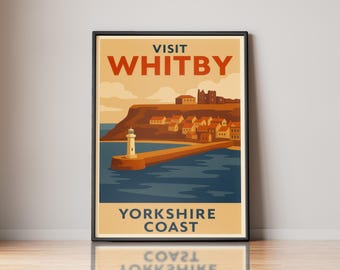 May include: A framed travel poster featuring a coastal scene of Whitby with a lighthouse, a stone pier, and buildings on a cliff. The text reads VISIT WHITBY at the top and YORKSHIRE COAST at the bottom in dark blue and orange lettering.