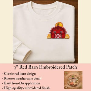May include: A cream-colored crewneck sweatshirt featuring a 3-inch embroidered patch of a red barn with a yellow sun and a rooster weathervane. The barn has white trim, two windows, and double doors, flanked by yellow hay bales on a plain fabric background.