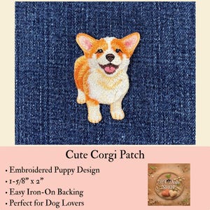 May include: An embroidered iron-on patch featuring a tan and white Corgi puppy with pointed ears, a black nose, and an open mouth showing a pink tongue. The patch measures 1-5/8 inches by 2 inches and is displayed against a dark blue denim fabric.