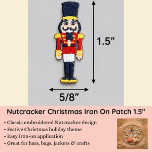 May include: An embroidered nutcracker patch featuring a dark blue hat, red jacket with yellow accents, and dark blue trousers. The patch measures 1.5 inches in height and 5/8 inches in width, as indicated by the black dimension arrows in the image.