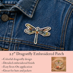 May include: A 2.5-inch dragonfly embroidered patch featuring a colorful design with orange, yellow, and blue tones. The patch is displayed on a blue denim jacket. The text 2.5” Dragonfly Embroidered Patch is visible below the patch.
