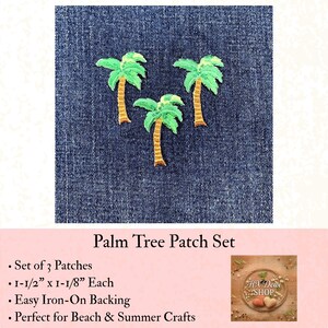 May include: A set of three embroidered palm tree patches featuring green fronds and brown trunks. Each patch measures 1-1/2 inches by 1-1/8 inches and includes an iron-on backing. The patches are displayed against a dark blue denim fabric background.