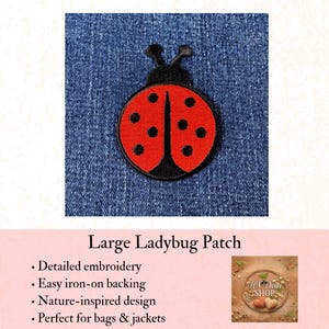 May include: A circular embroidered patch featuring a red ladybug with black spots and a black head with two antennae. The patch is displayed against a blue denim fabric background. The design includes a central black line dividing the red wings.