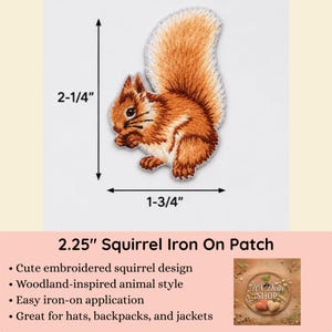 May include: An embroidered squirrel patch featuring shades of orange, brown, and white thread. The patch measures 2-1/4 inches in height and 1-3/4 inches in width as indicated by the black dimension arrows. The squirrel is depicted in a seated position.