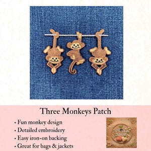 May include: An embroidered patch featuring three brown monkeys hanging from a horizontal line. The monkeys are rendered in shades of light and dark brown thread with cream-colored faces and black stitched details for their eyes and smiling mouths.