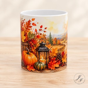 May include: A white ceramic mug featuring a vibrant autumn scene with a black lantern, a large orange pumpkin, a smaller green pumpkin, pinecones, and colorful fall foliage including red and orange maple leaves against a landscape.