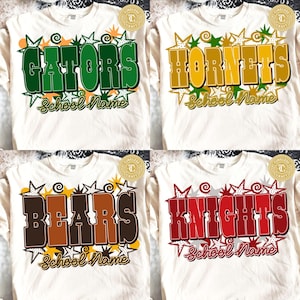 May include: Four white t-shirts featuring graphic designs with large block letters spelling GATORS, HORNETS, BEARS, and KNIGHTS. Each design includes star shapes, swirls, and the text School Name in a cursive font below the main team name.