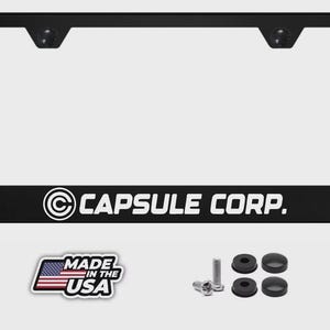 May include: Black license plate frame with the text "CAPSULE CORP." in white. Includes mounting hardware and a "MADE IN THE USA" sticker. The frame is rectangular with a clear window.