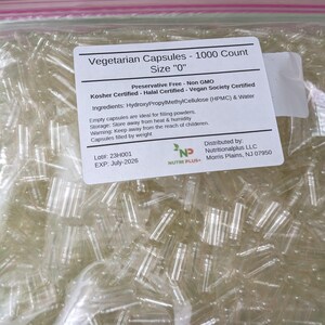 May include: A clear plastic bag filled with numerous empty vegetarian capsules. The bag has a label that reads "Vegetarian Capsules - 1000 Count, Size '0'". The label also lists ingredients and certifications.