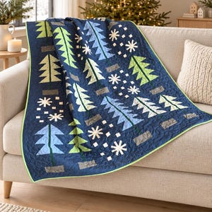 May include: A navy blue quilt featuring a repeating pattern of stylized evergreen trees in shades of lime green, light blue, and white, interspersed with white snowflake motifs and small gray rectangular tree bases, finished with a lime green trim.