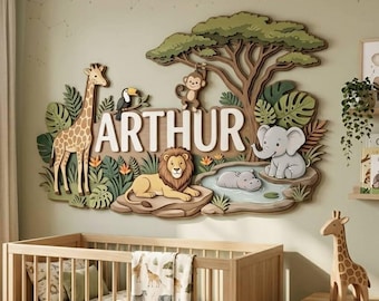 May include: A multi-layered wooden wall art piece featuring the name ARTHUR in large white letters, surrounded by a giraffe, a lion, a monkey, an elephant, and a hippo in a jungle setting with a tree, green foliage, and a small blue pond.
