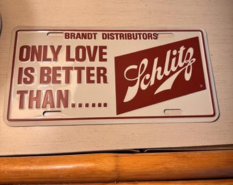 Plaque d'immatriculation vintage pour bière Schlitz - « Seul l'amour vaut mieux que… » Distributeurs Brandt