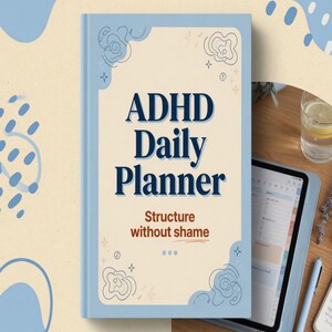 May include: A light blue daily planner with a cream-colored center panel featuring the dark blue text ADHD Daily Planner and the brown text Structure without shame, decorated with thin dark blue line art doodles in the corners.