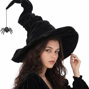 May include: A black velvet witch hat with a wide, floppy brim and a tall, pointed crown. A small, dark, multi-legged spider ornament hangs from a thin black string attached to the very tip of the hat, dangling beside the crown.