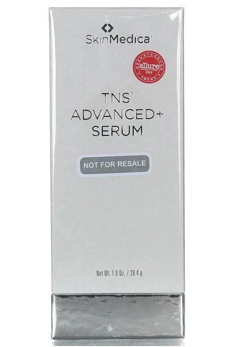 May include: A rectangular SkinMedica TNS Advanced+ Serum box in white with a silver base. The front features the brand logo, an Allure 2019 award seal, the product name, a Not For Resale label, and the net weight of 1.0 Oz. / 28.4 g.