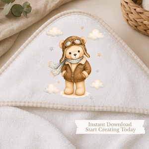 May include: A white hooded towel featuring a central illustration of a light brown teddy bear dressed as an aviator in a brown leather jacket, goggles, and a scarf, surrounded by clouds and stars. The text reads: Instant Download Start Creating Today.