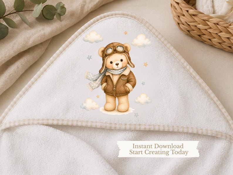 May include: A white hooded towel featuring a central illustration of a light brown teddy bear dressed as an aviator in a brown leather jacket, goggles, and a scarf, surrounded by clouds and stars. The text reads: Instant Download Start Creating Today.