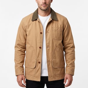 May include: A tan work jacket with a green corduroy collar, four front pockets, and brown buttons. The jacket is worn over a white t-shirt. The jacket is a classic style.