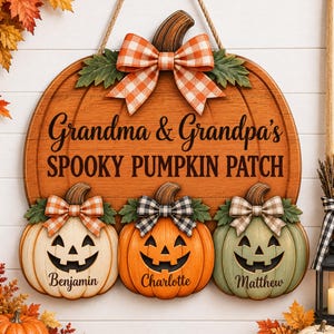 May include: A wooden pumpkin-shaped wall sign featuring the text Grandma & Grandpa's SPOOKY PUMPKIN PATCH. It includes three smaller jack-o'-lanterns below, labeled Benjamin, Charlotte, and Matthew, each adorned with a decorative fabric bow.