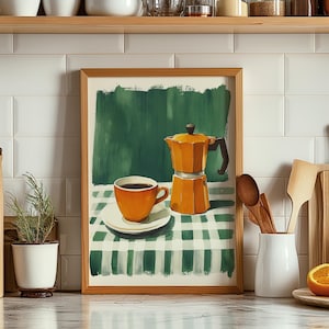 May include: A framed art print depicts a still life with a coffee cup and a stovetop espresso maker. The cup and maker are orange, set on a green and white checkered tablecloth. The background is a green painted design.