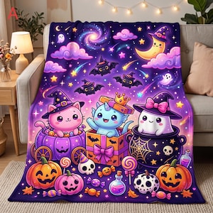 May include: A plush throw blanket featuring a vibrant Halloween-themed illustration with a purple galaxy background, a pink cat in a pumpkin carriage, a blue creature in a gift box, a white ghost in a cauldron, pumpkins, and candy.