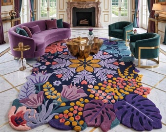 May include: A large, irregularly shaped area rug featuring a dark blue background with a vibrant, multi-colored floral and botanical pattern. The design includes stylized purple, yellow, and pink flowers, along with large, textured green and purple leaves.