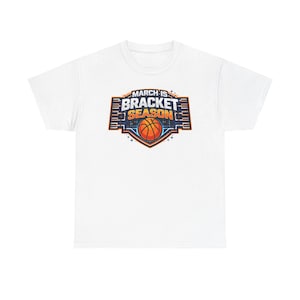 May include: White t-shirt with a basketball-themed graphic. The graphic features a basketball inside a shield with the words "MARCH IS BRACKET SEASON" in blue, orange, and white.