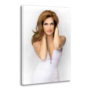 May include: A canvas print featuring a woman with long auburn hair, wearing a white dress with a deep V-neckline. The woman is posing with her hands near her head, and the background is plain white.