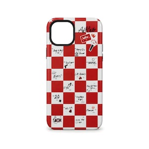 Op de afbeelding: Een rood-witte geruite telefoonhoes met diverse handgeschreven zinnen en kleine illustraties. De hoes heeft het woord "ARIRANG" bovenaan, samen met andere woorden en zinnen zoals "Aliens", "2.0" en "SWIM".
