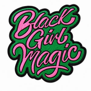 May include: An embroidered patch featuring the text Black Girl Magic in bright pink cursive lettering. The words are set against a vibrant green background with a thick black border that follows the contour of the text, creating a bold shape.