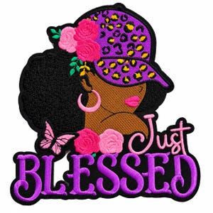 May include: An embroidered patch featuring a person with dark skin, black hair, and a purple leopard print cap. The design includes pink roses, a pink butterfly, pink hoop earrings, and the text Just BLESSED in purple and pink lettering.